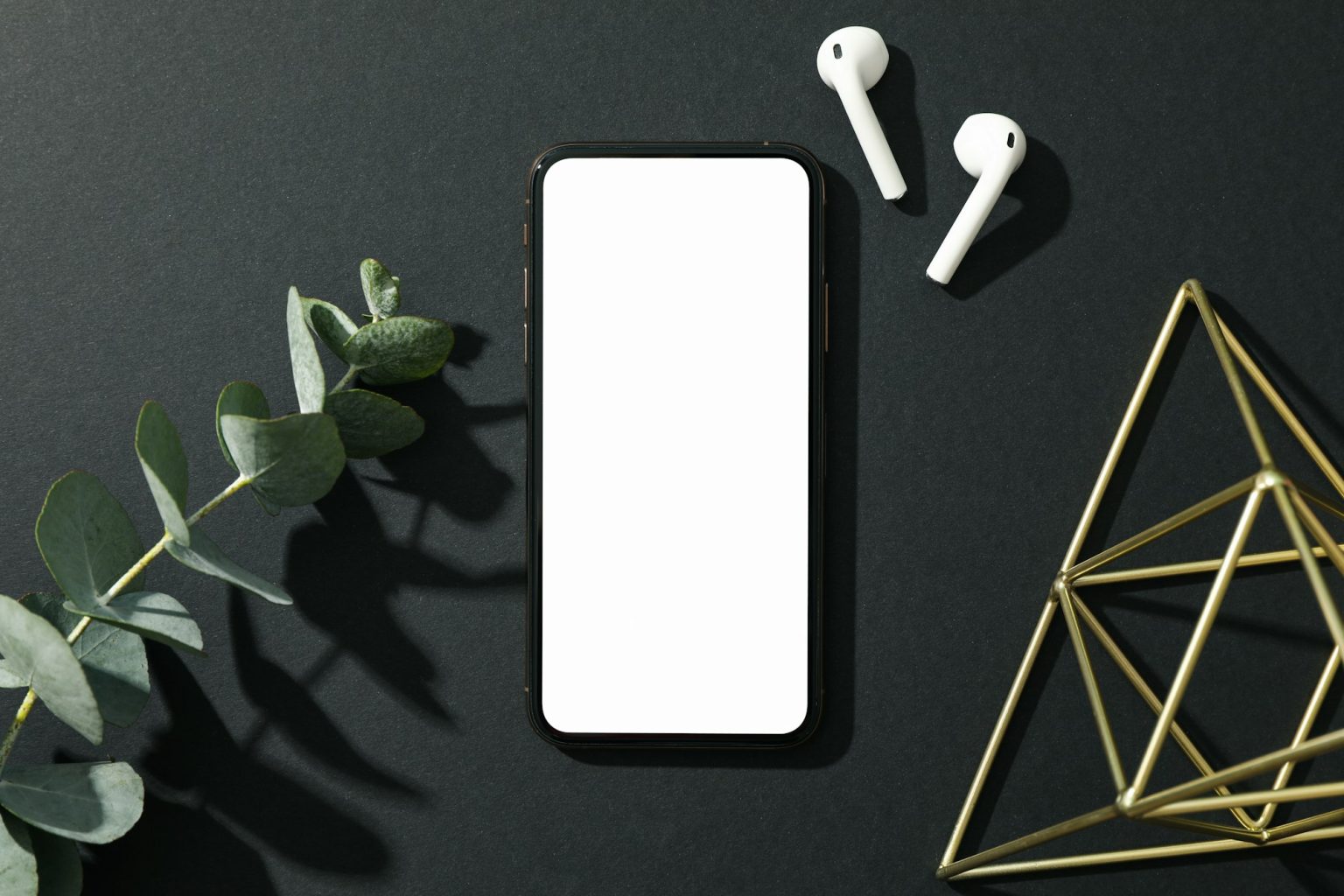 phone-with-empty-screen-on-black-decorated-background-top-view-1536x1024